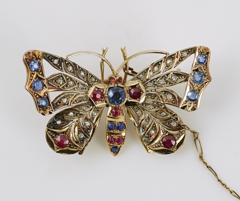 An Edwardian gold, ruby, sapphire and rose cut diamond set butterfly brooch